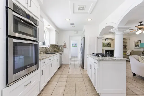 a large kitchen with a stove top oven