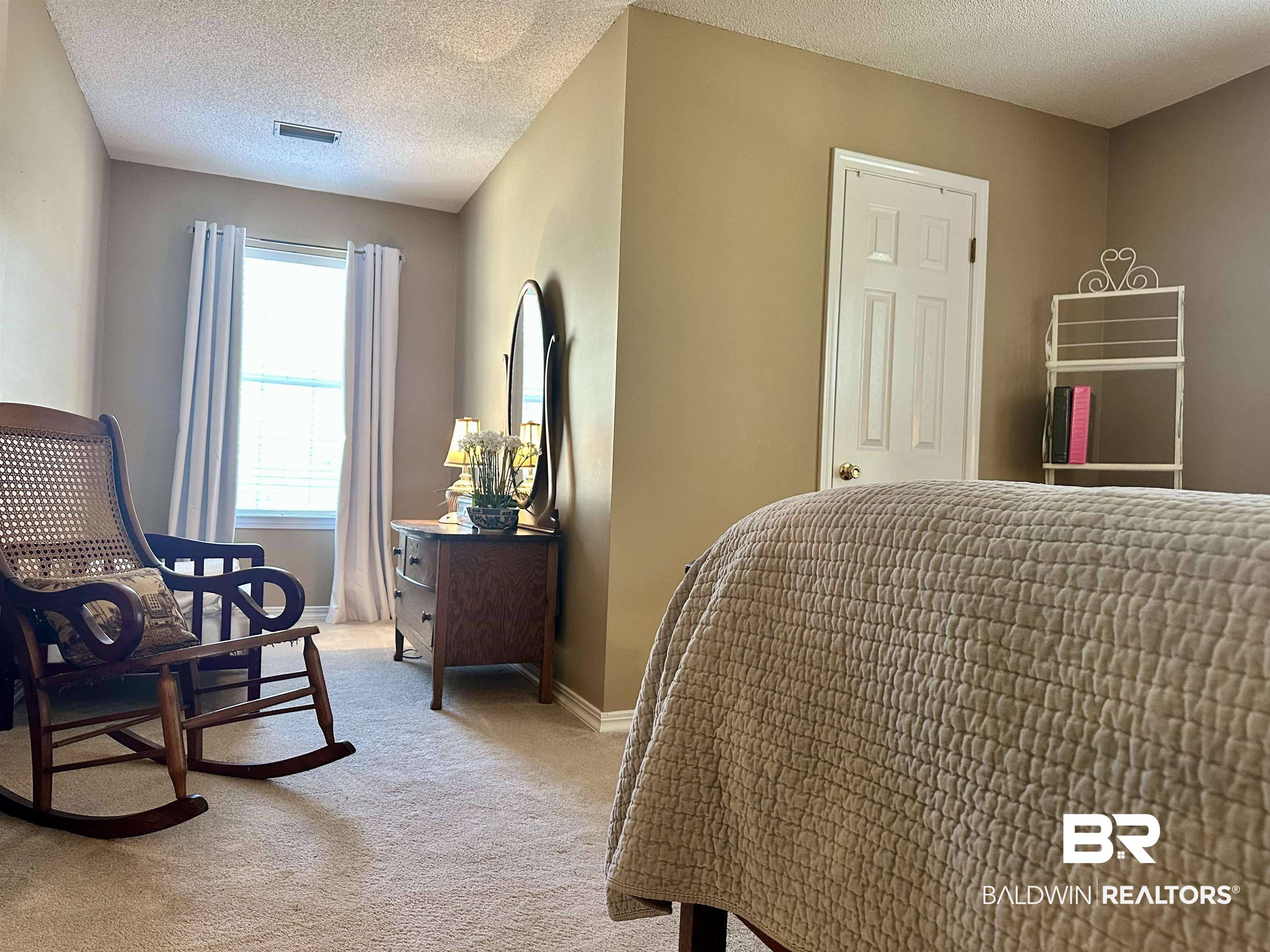 148 Brooks Boulevard Brewton, AL 36426 - Photo 26 of 45 Bedroom featuring a textured ceiling, baseboards, visible vents, and light carpet