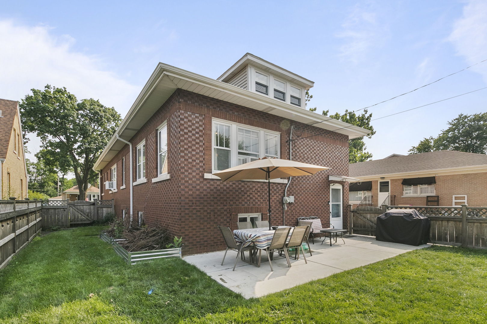 118 Northgate Road Riverside, IL 60546 - Photo 20 of 29 a view of a patio with table and chairs potted plants and a large tree
