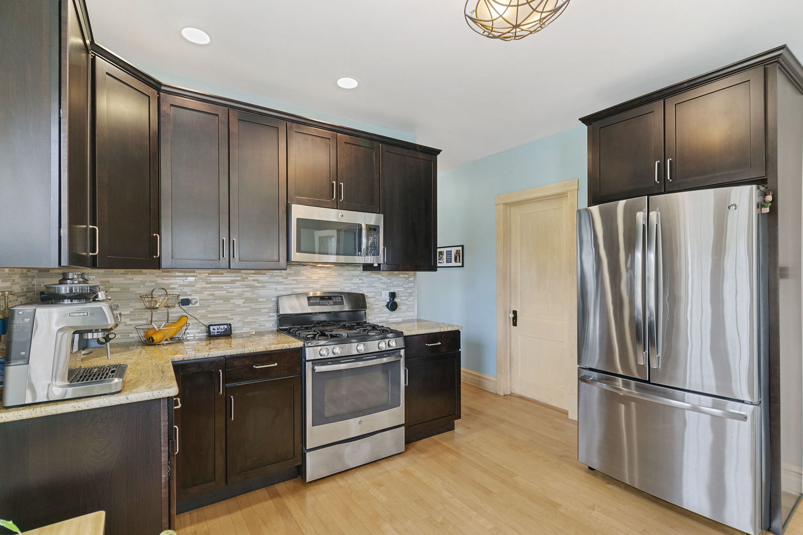 118 Northgate Road Riverside, IL 60546 - Photo 2 of 29 a kitchen with stainless steel appliances granite countertop a refrigerator stove a sink and a microwave