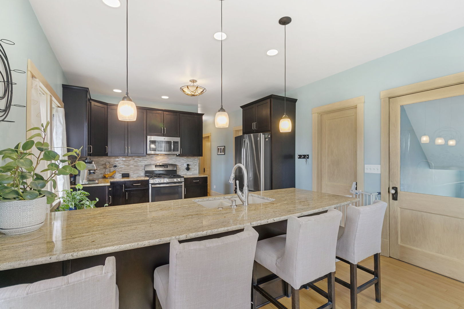 118 Northgate Road Riverside, IL 60546 - Photo 5 of 29 a kitchen with stainless steel appliances kitchen island granite countertop a dining table chairs and a white cabinets