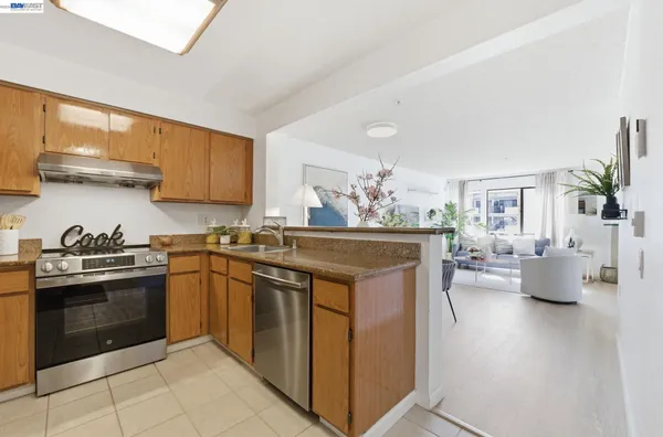 a kitchen with stainless steel appliances granite countertop a stove and a sink