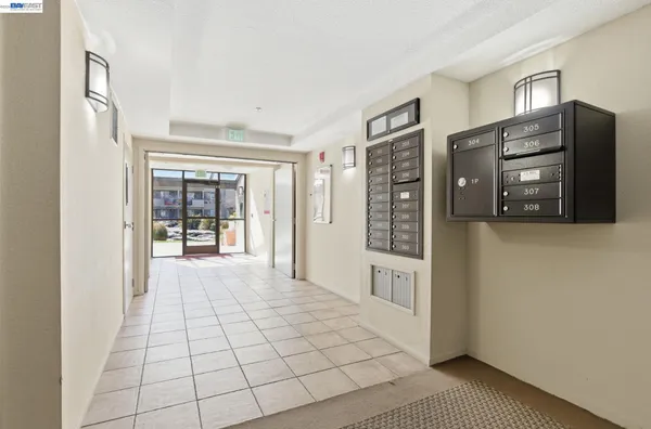 a view of a hallway with wooden floor and windows