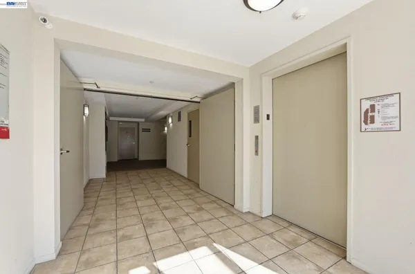 a view of a hallway with wooden shelves