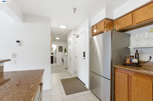 a kitchen with stainless steel appliances granite countertop a refrigerator and a sink