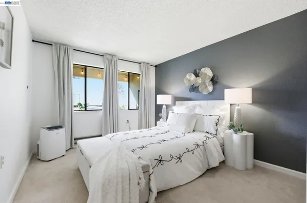 a bedroom with a bed and a chandelier