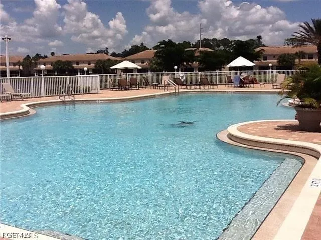a view of a patio with swimming pool and furniture