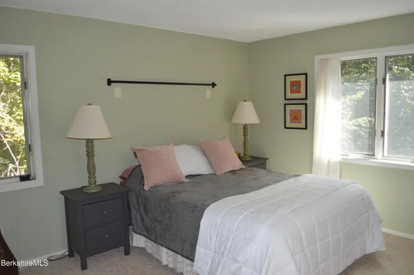 a balcony with wooden floor and outdoor seating