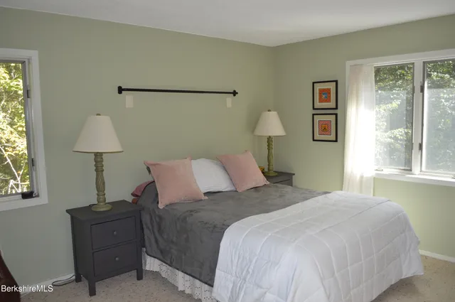 a balcony with wooden floor and outdoor seating