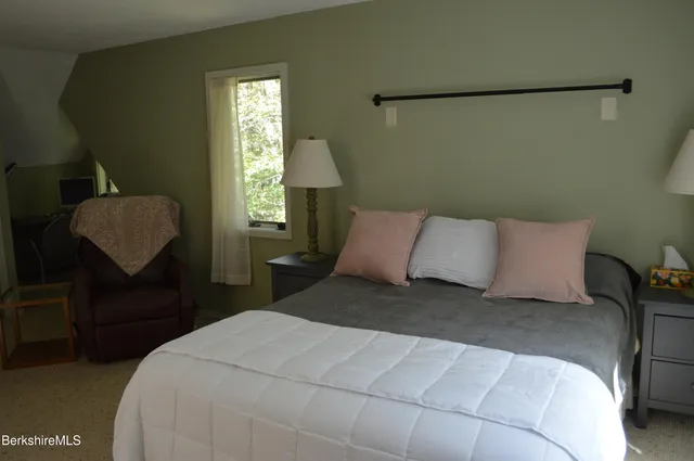 a roof deck with table and chairs a barbeque with wooden floor and fence