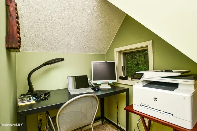 a front view of a house with table and chairs and a barbeque