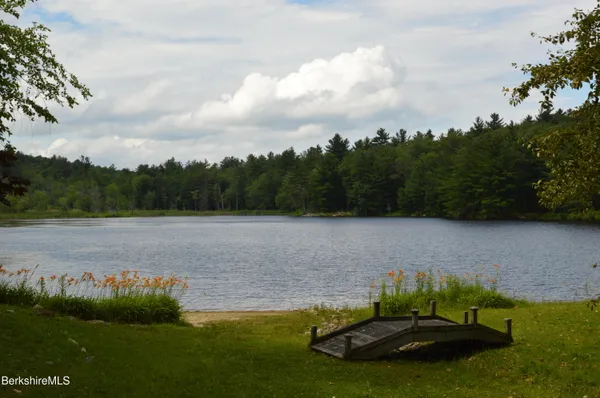 an outdoor sitting area with furniture and wooden roof