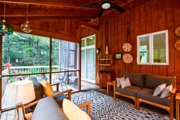 a living room with furniture and a floor to ceiling window