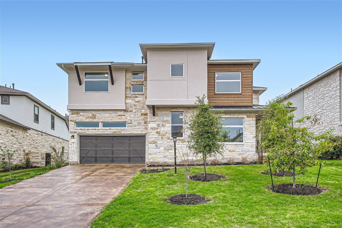 a front view of a house with a garden