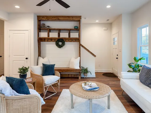 a living room with furniture and wooden floor