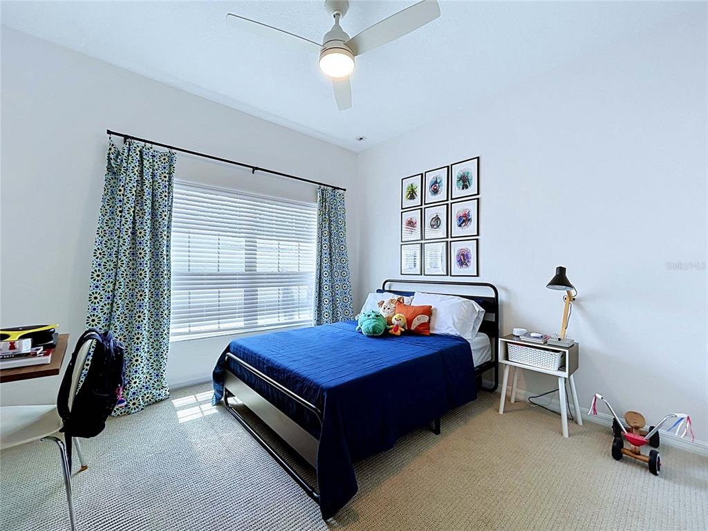 18078 Romanesque Court Spring Hill, FL 34610 - Photo 43 of 81 a blue bed sitting in a room next to a window