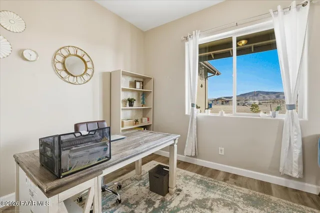 a room with a large window and a bed