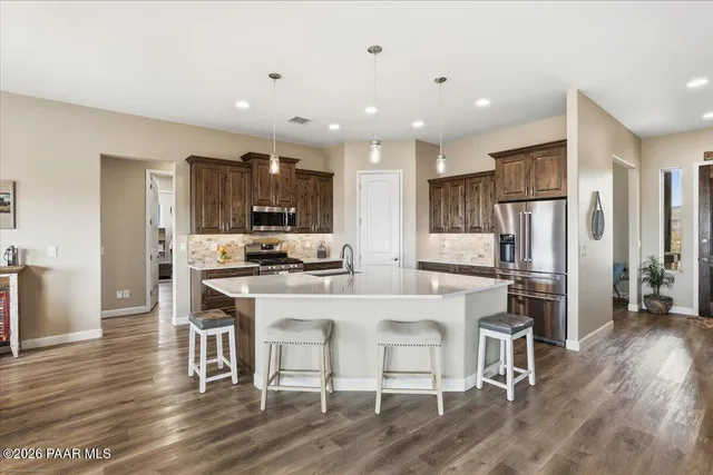 a kitchen with stainless steel appliances granite countertop lots of counter top space and furniture