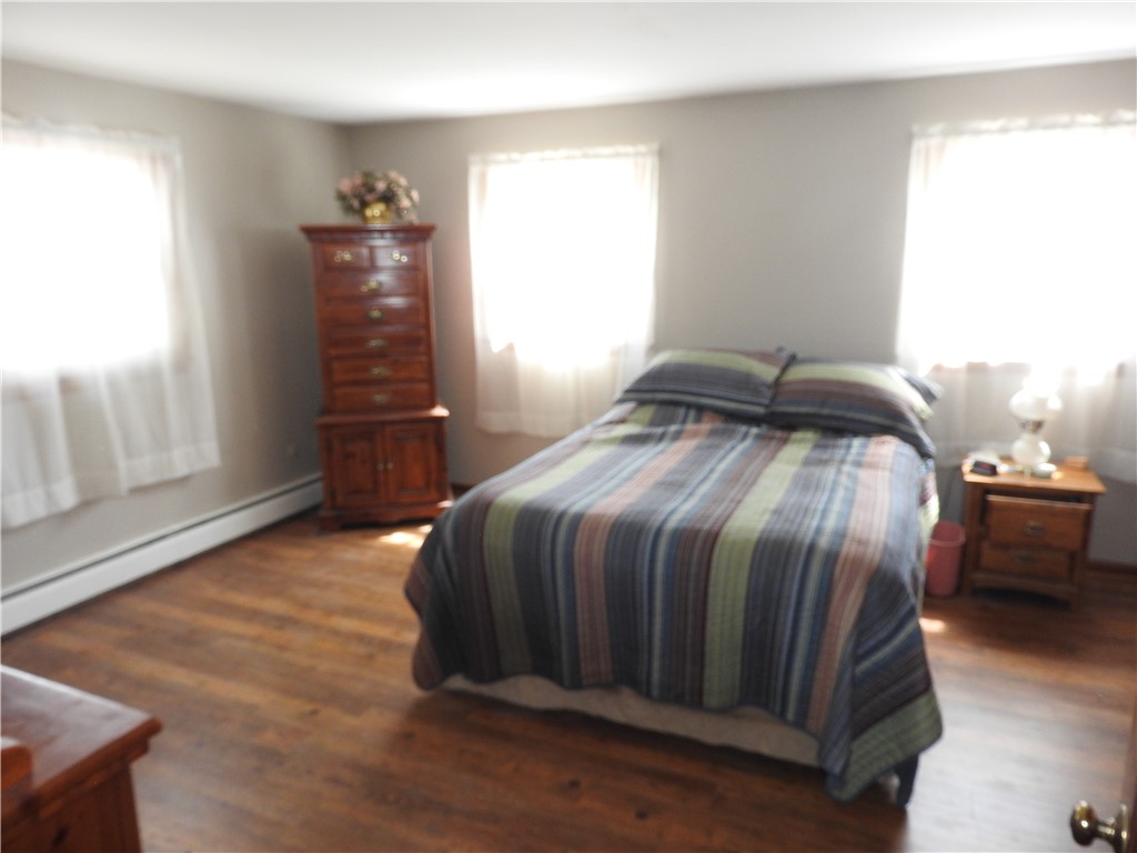 2185 East Loy Road Piqua, OH 45356 - Photo 13 of 19 Bright and airy room with polished hardwood floors, offering a serene personal retreat.