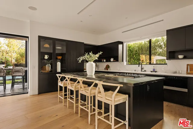 a living room with furniture and large windows