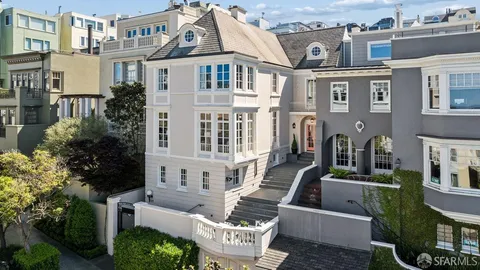 a living room with furniture fireplace and a potted plant
