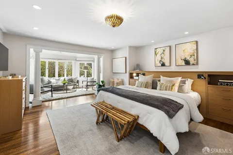 a living room with furniture and a floor to ceiling window