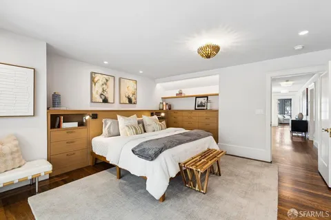 a view of a dining room with furniture next to a window