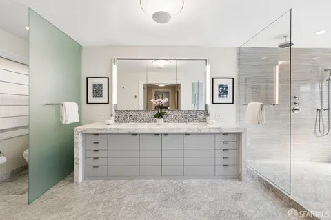 a bathroom with a sink a mirror and shower