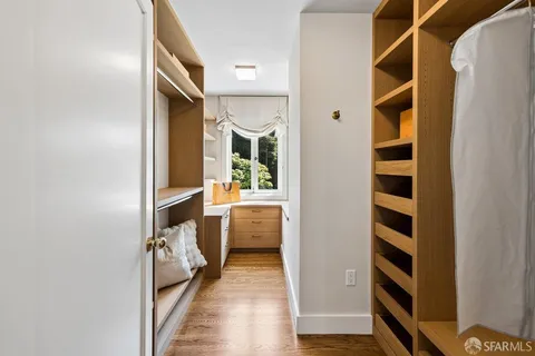 a bedroom with a bed and a view of living room