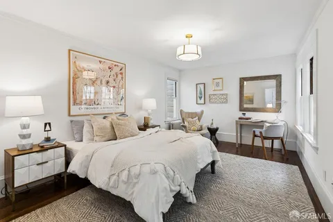 a bedroom with a large bed and a large window