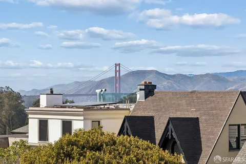a living room with furniture chandelier and wooden floor