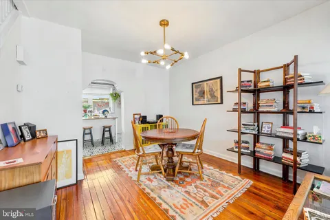 a dining room with furniture and wooden floor