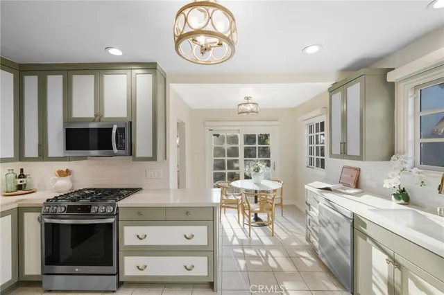 a kitchen with stainless steel appliances granite countertop a refrigerator sink and cabinets