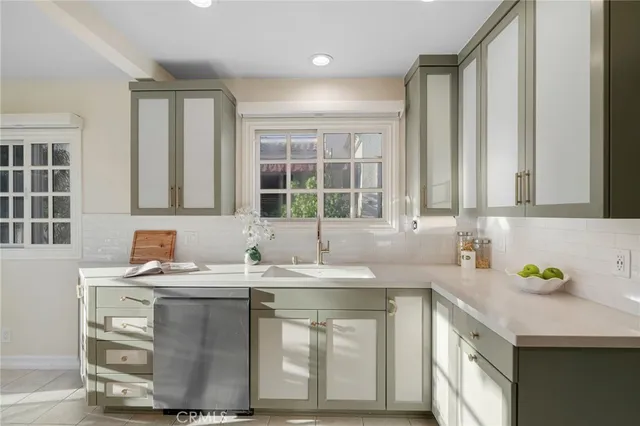 a kitchen with a refrigerator and a sink