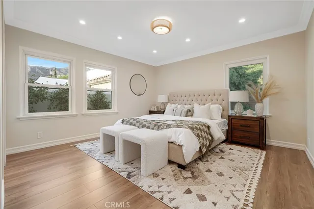 a spacious bedroom with a large bed and a chandelier