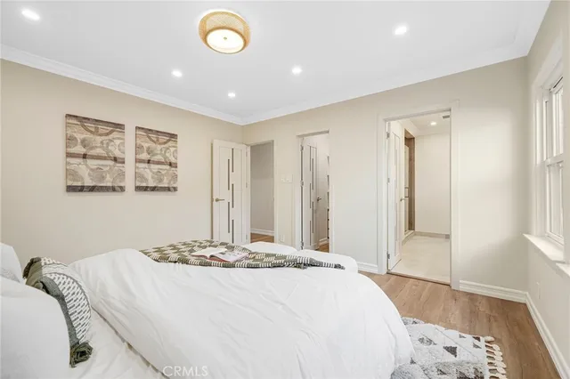 a bedroom with a large bed and a chandelier