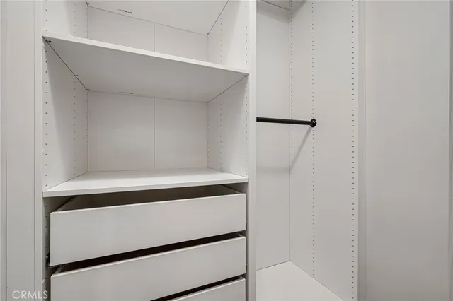 a bedroom with bed and wooden floor