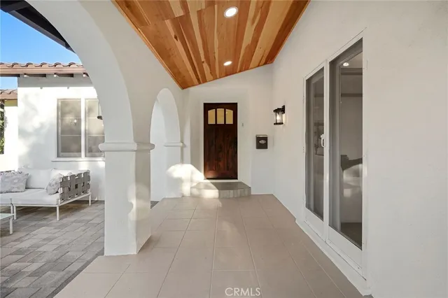 a front view of a house with a couch and chairs