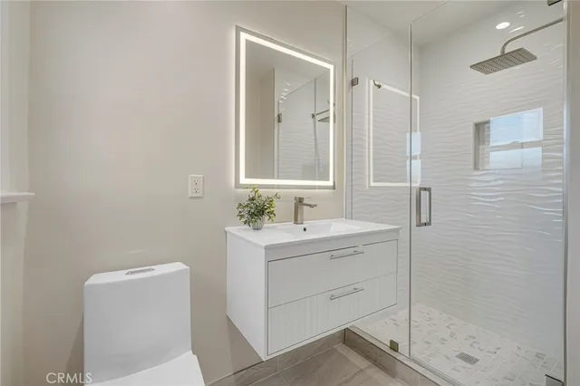 a white house that has a tree in front of it