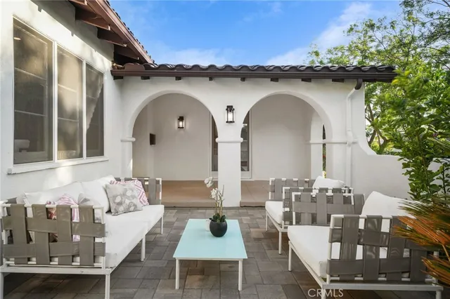 a living room with furniture a fireplace and a chandelier