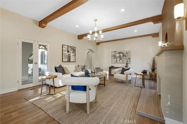 a living room with fireplace furniture and a large window