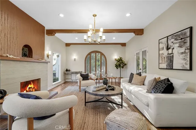 a living room with fireplace a dining table and a fireplace