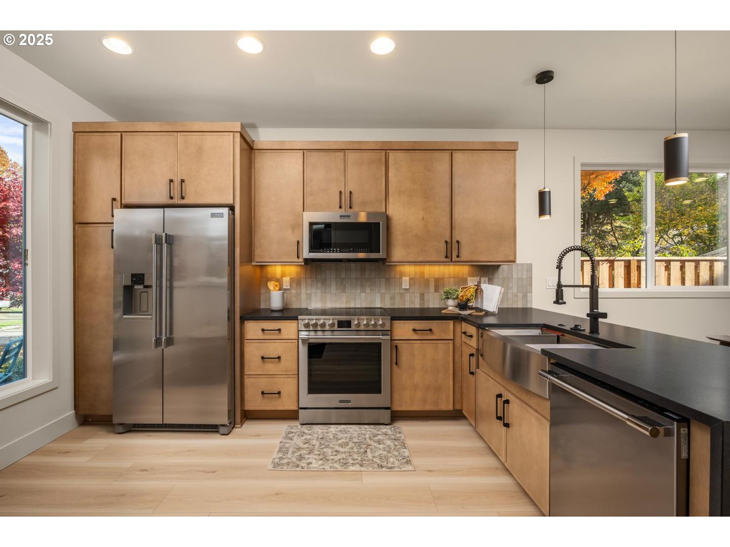 2620 North Kilpatrick Street Portland, OR 97217 - Photo 13 of 37 a kitchen with stainless steel appliances granite countertop a stove a sink dishwasher a refrigerator and a microwave