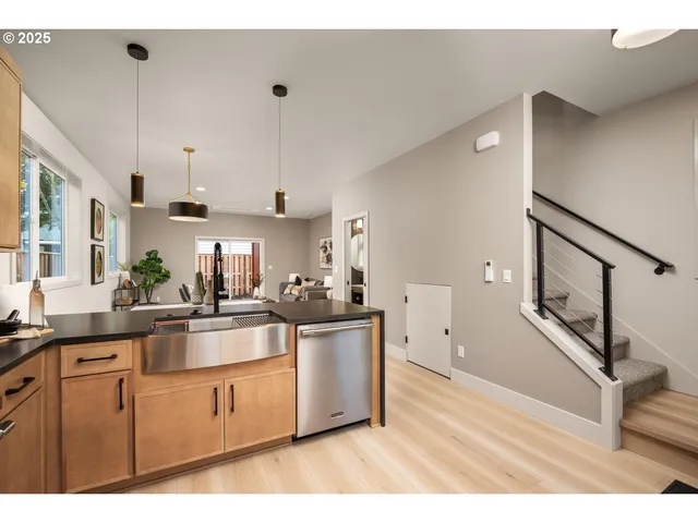 a kitchen with stainless steel appliances granite countertop a sink stove and refrigerator