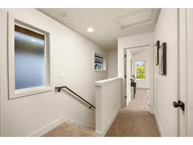 a view of hallway with furniture and a wooden floor