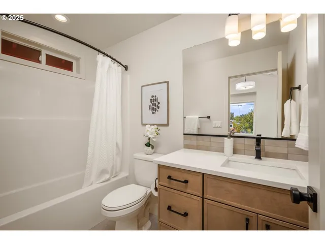 a bathroom with a sink toilet a mirror and shower