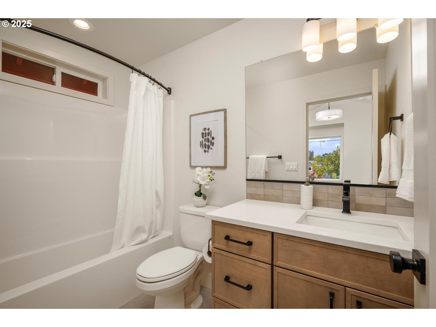 2620 North Kilpatrick Street Portland, OR 97217 - Photo 21 of 37 a bathroom with a sink toilet a mirror and shower