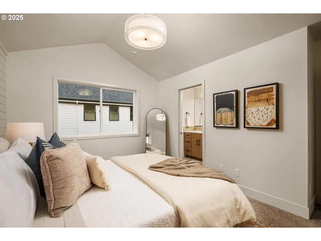 a bedroom with a bed and a painting on the wall