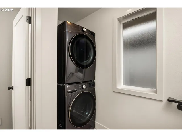 a view of a hallway with washer and dryer