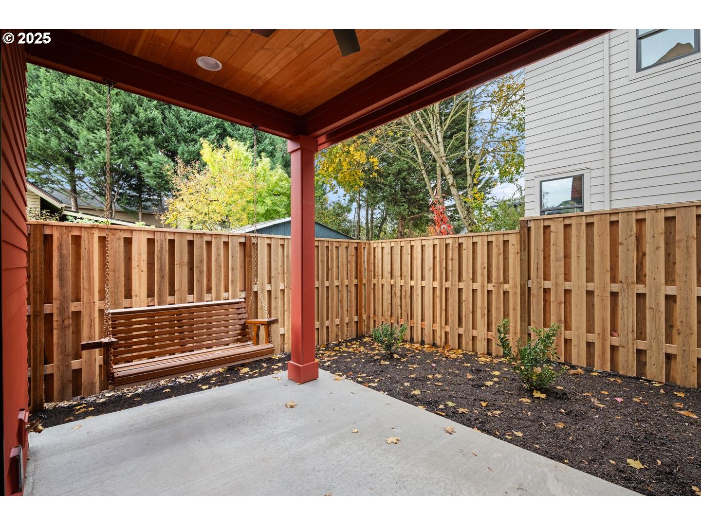 2620 North Kilpatrick Street Portland, OR 97217 - Photo 29 of 37 a backyard of a house with a floor to ceiling window and wooden fence